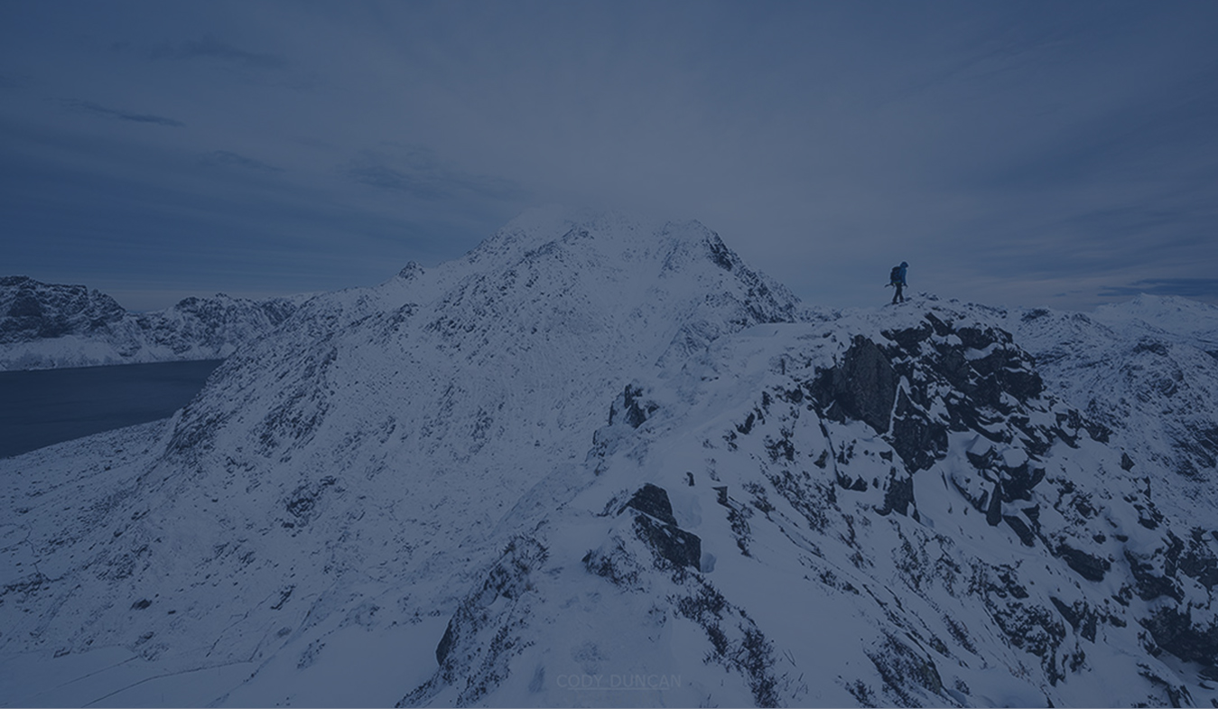 Hiker on snowy mountain peak.